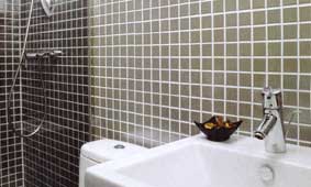 Stainless steel mosaic bathroom tiles add a luxurious