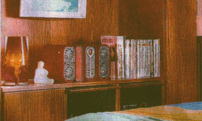 Home Storage Ideas: Close-up of space-saving wardrobe nook which houses a plasma tv, display area and writing desk