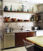 Walnut shelves display the owner's collection of wooden bowls and pottery