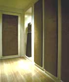 Suede covered panels on the walls which double as doors