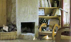 White textured contemporary fireplace matches the pale color scheme of the interior