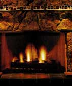 Consistently sized pictures of family and friends contrast with the irregular stones in this rustic fireplace