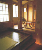 Varying flooring level defining the dining space and leading to the bedroom and bathroom