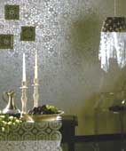 The contemporary rococo wallpaper print brings out the laser-cut fabric draped over the hanging lamp