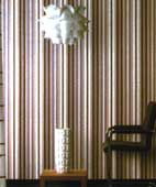 Organic shape of the hanging lamp contrasts with the verticle striped wallpaper 