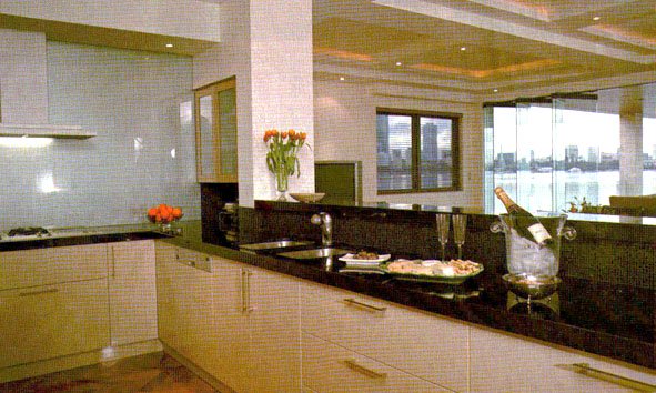 Kitchen Renovation Guide: Open plan kitchen with granite benchtops and glass splashback