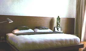 Partial Wall Cladding Matches the Bedroom Furnishing 