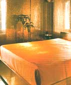 Bedroom wall decor, inclusive of ceiling and floor covered in gold mosaic